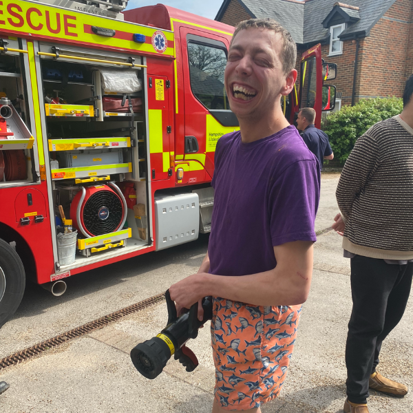 Male JP member with a camera to photograph a fire truck