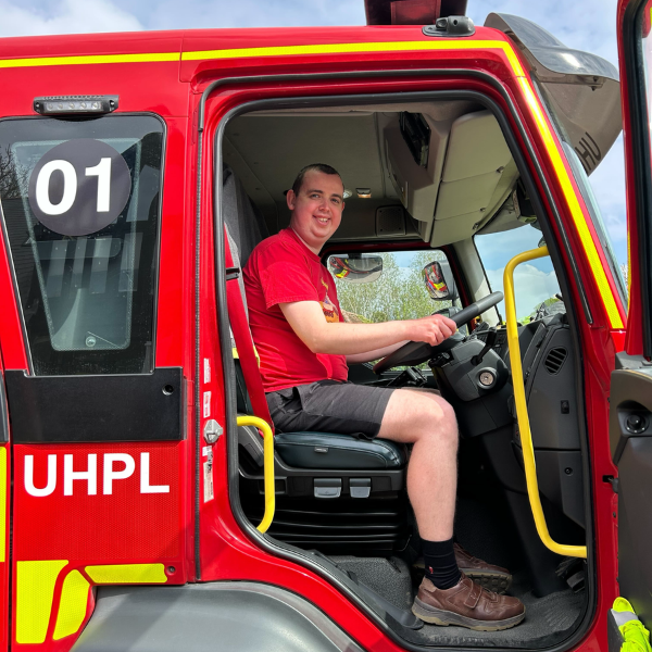 male JP Basingstoke member behind the steering wheel of a fire engine