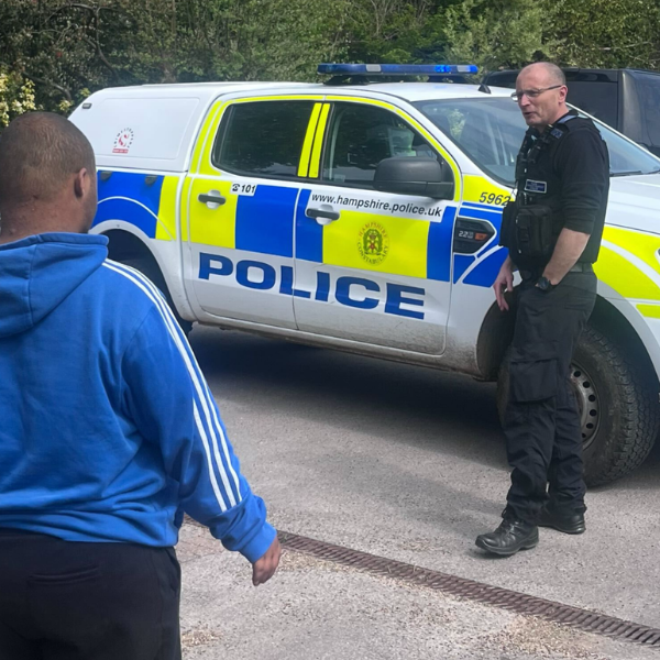 Male JP Basingstoke member and a polieman with a police car