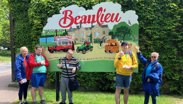Beaulieu banner members from eastleigh standing in front of the sign