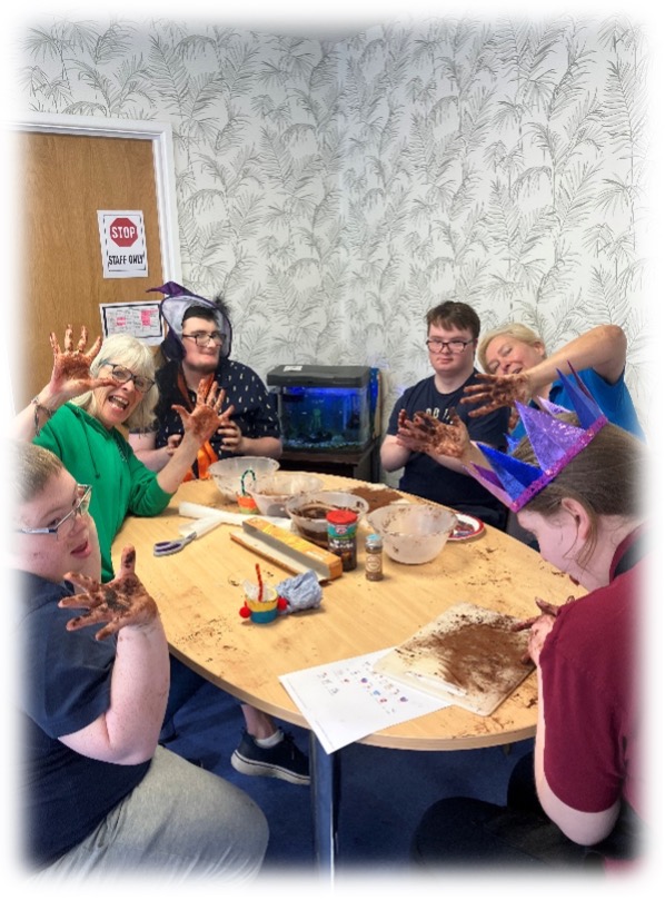 jp members with messy hands from cake making 