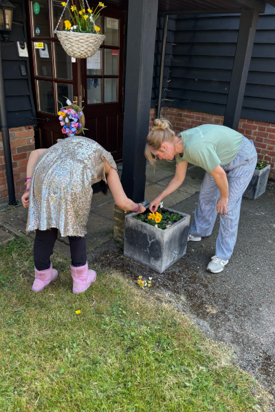 James' Place Adult Daycare Reading West members planting colourful plants and flowers for spring